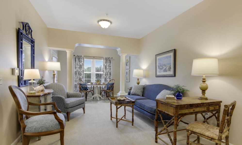 Bright apartment living room with sofa, armchairs and a dining nook