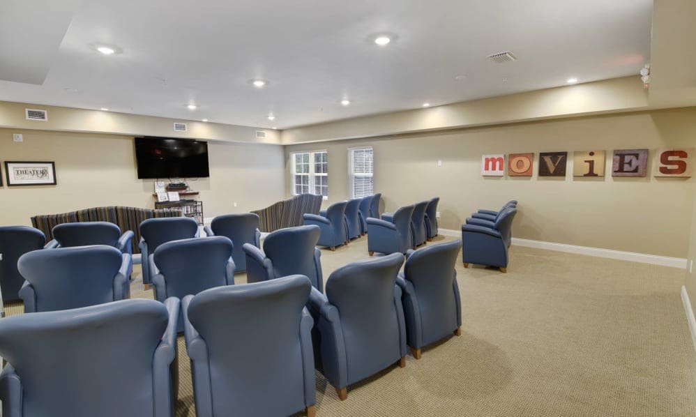 Theater room with rows of padded armchairs