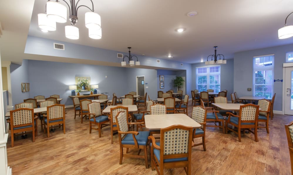 Community dining room with tables set for residents