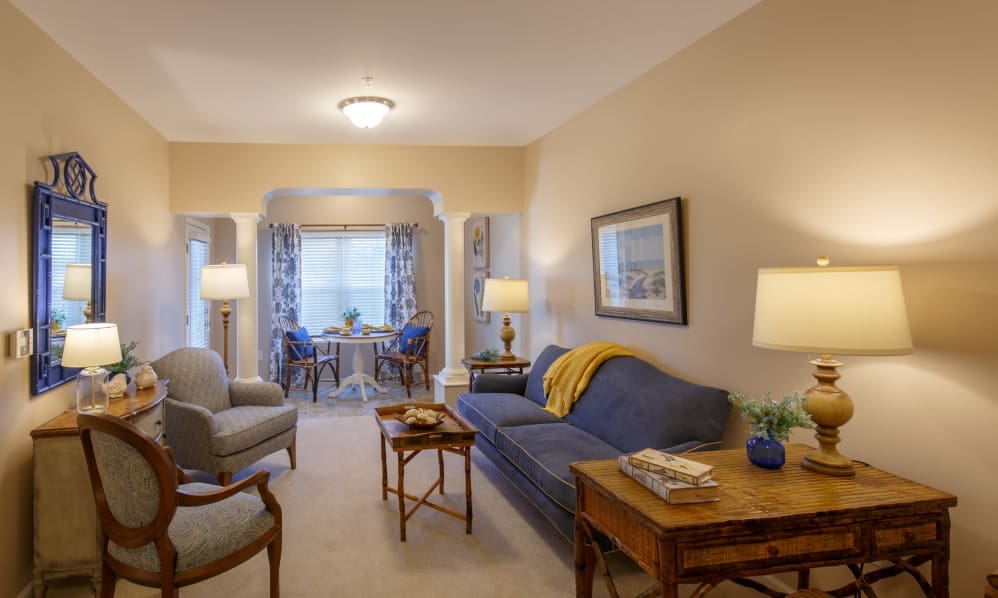 Apartment living room with sofa, armchairs and a writing desk