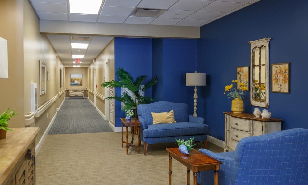 Hallway lounge with blue armchairs and a sofa
